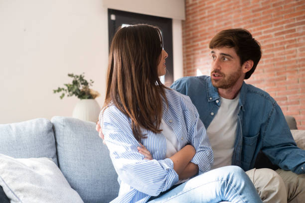 istock Sad and angry girl thinking about relationship problems sitting on sofa with offended boyfriend, conflicts in marriage, upset couple after dispute, making decision to break up and divorce 2167343107