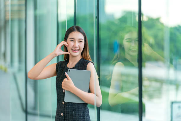 istock Young Woman Holding A Tablet, Looking Away Smiling 2167343138