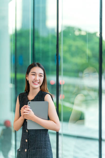 istock Young Woman Holding A Tablet, Looking Away Smiling 2167343145