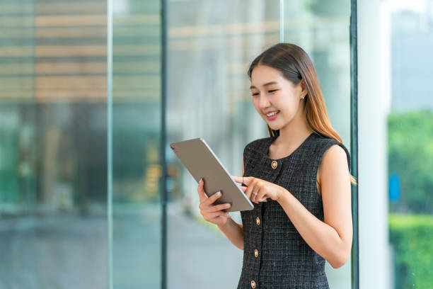 istock Young Asian Businesswoman Using A Tablet 2167343345
