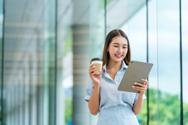 istock Young Woman Using Tablet While Having A Cup of Coffee 2167343722