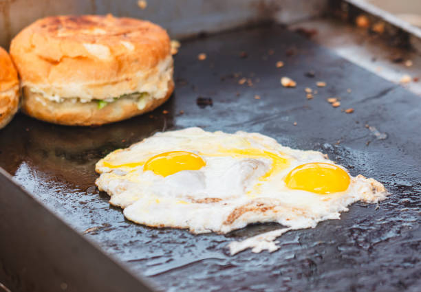 istock Eggs are fried in oil on a metal plate 2167344772