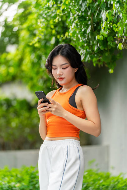 istock Young Woman Using Phone In a Park Casually 2167346908