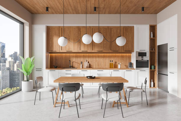 istock Stylish home kitchen interior with eating table and chairs, panoramic window 2167346961