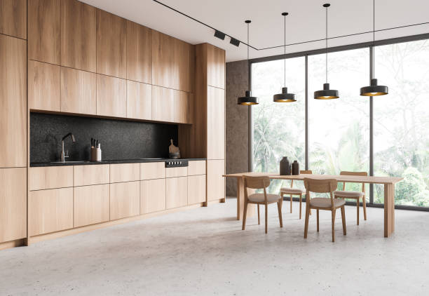 istock Home kitchen interior with dinner table and cooking cabinet. Panoramic window 2167346988