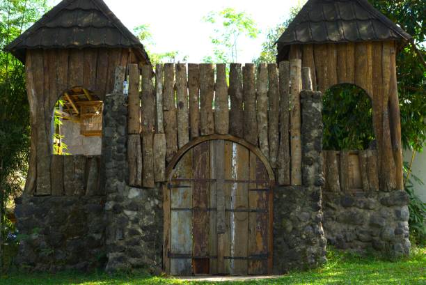 castle like building made from wood with entrance door gate and window, outdoor playground park