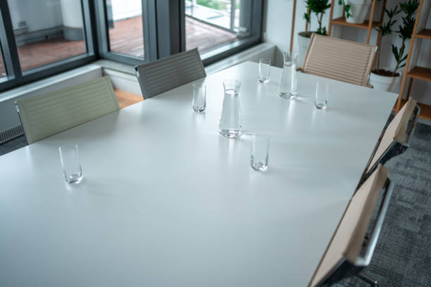 Chairs in the interior. White table and red chairs. Empty seats in the restaurant. Dinner table.