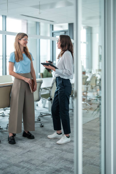 istock Caucasian and Hispanic Female Professionals in Office Discussion 2167349250