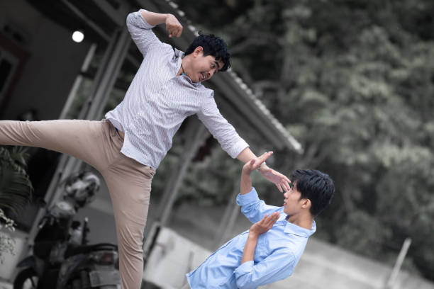 Resolve a problem like a men. A guy punches another man in the face. fight between men
