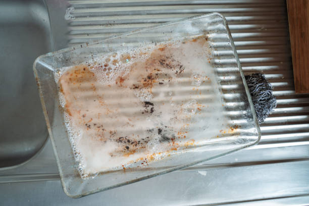 istock Dirty Glass Tray Being Cleaned in Kitchen Sink with steel wool 2167350102