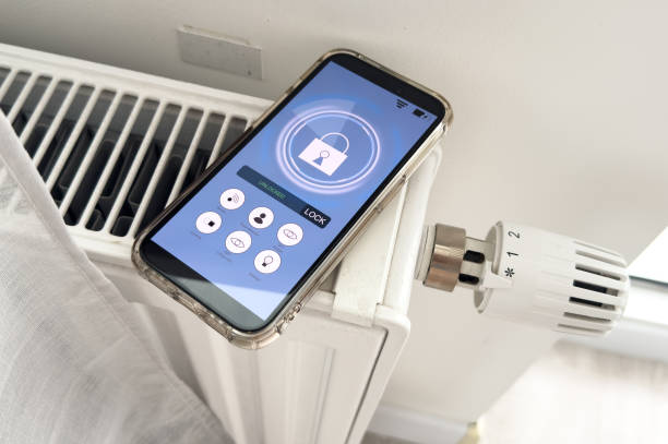 istock Adjusting Temperature Of Digital Smart Thermostat Using Mobile Phone App At Home 2167351063