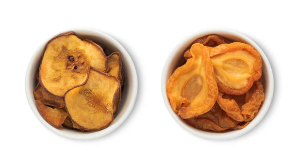 Bowl plates with dried sweet organic pear pieces isolated on white background.Top view. stock photo