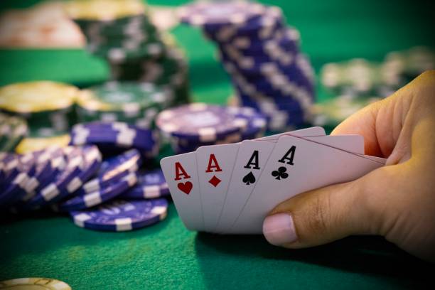 istock Hands with poker cards and chips on poker table 2167352099