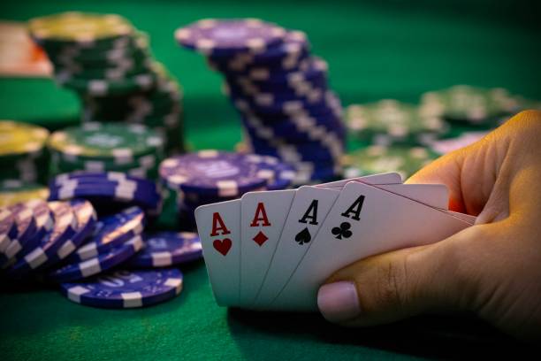 istock Hands with poker cards and chips on poker table 2167352108