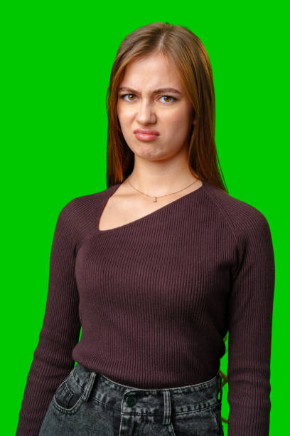 istock Young Woman With Disgruntled Expression Against Green Screen 2167352342