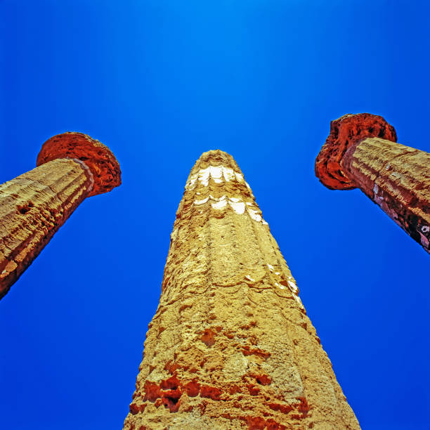 Close up view of the columns bases from the temple of Dioscuri with the town of Agrigento behind