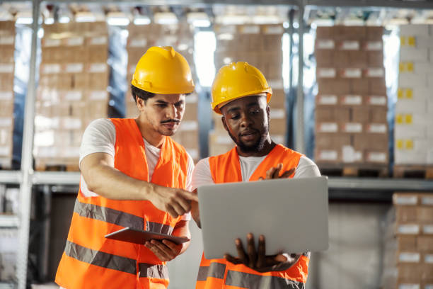 istock Multicultural warehouse logistics manager working on fast distribution on laptop with his colleague. 2167353165