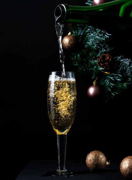 istock Sparkling wine poured into the champagne glass on black 2167354920