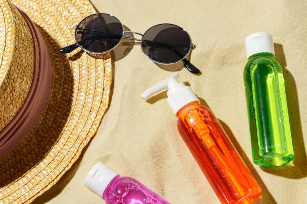 istock Colorful Sunscreen Bottles Arranged on Sandy Beach With Summer Essentials 2167355013