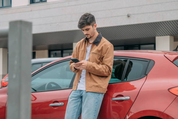 istock Casual young man using mobile phone on street 2167355622