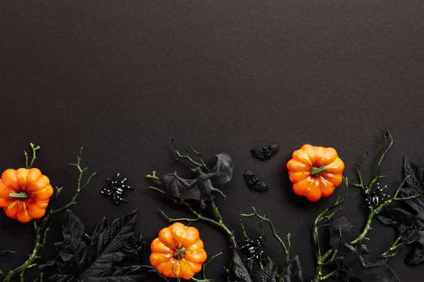 istock Scary Halloween flat lay composition with orange pumpkins, branches with bats, spiders on black background. Halloween party invitation card mockup. Flat lay, top view, copy space. 2167357475