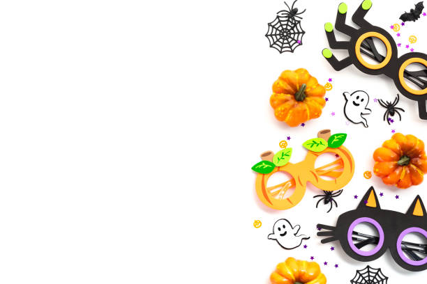 istock Halloween party sunglasses with decorations on white background. Halloween concept. Flat lay, top view, copy space 2167358327