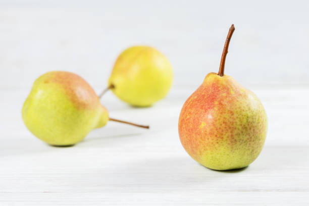 istock Ripe pears on white wooden background 2167358423