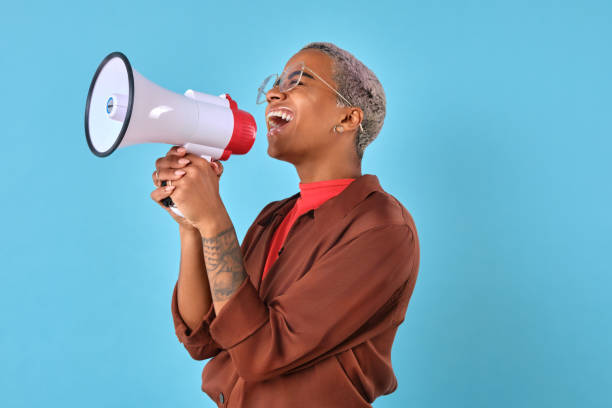 istock Celebrating empowerment with a megaphone against a vibrant blue backdrop 2167358485