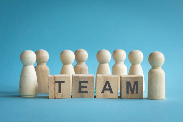 istock Team, word on wood blocks with people figures. 2167358922
