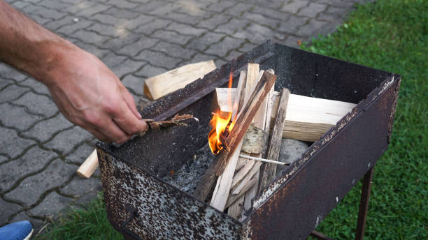 istock A hand is starting a fire in a grill for barbeque 2167359810