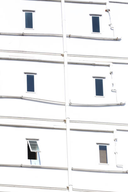 istock Windows of an apartment building on a white wall background. 2167361206