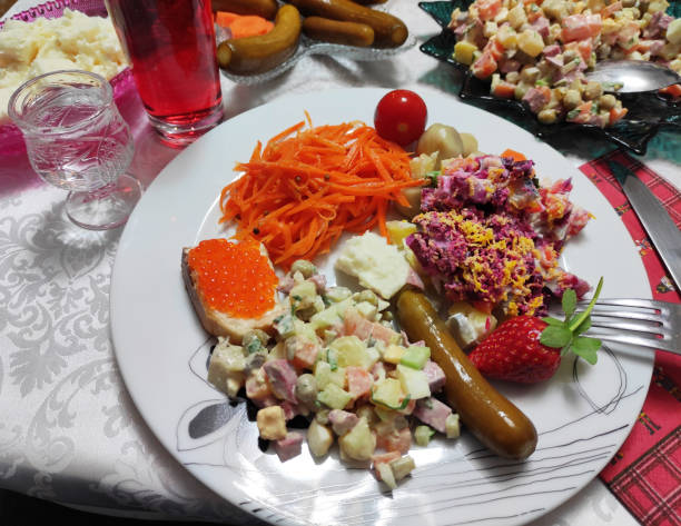 Festive New Year's table with salads, snacks, red caviar and drinks