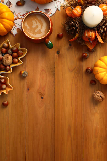istock Autumn flat lay composition with coffee cup, pumpkins, decorative candle with pine cones, leaf-shaped plate with nuts, acorns on wooden table. 2167362267