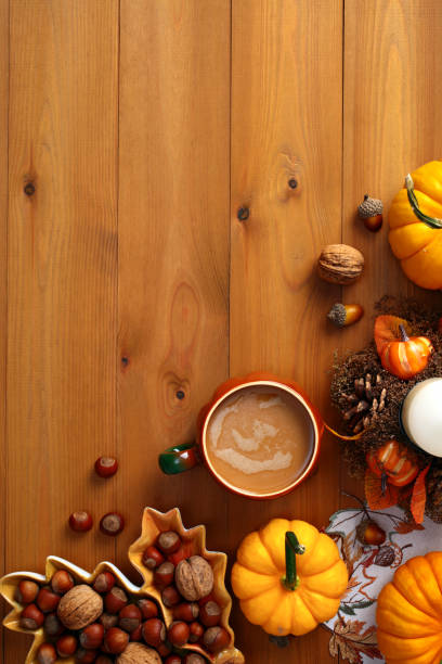 istock Creative Autumn flat lay composition with pumpkins, coffee cup, nuts, acorns, candle on wooden surface. 2167362741