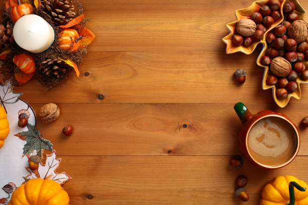 istock Top view Autumn background with pumpkins, leaf shaped plate with nuts, acorns, candle with pine cones, cloth on wooden table. Autumn holiday, fall concept. 2167362838