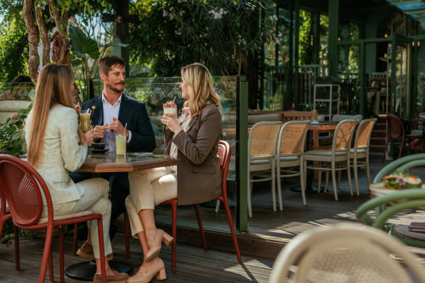 istock Three businesspeople sitting in a cafe 2167363221