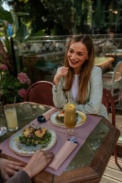 istock Friends dining at an outdoor restaurant with lush greenery 2167363248