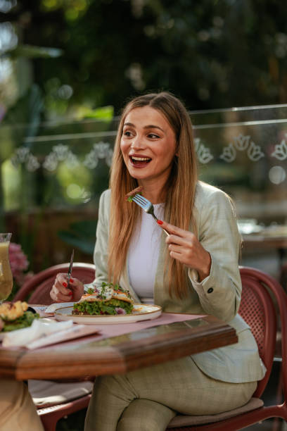 istock Woman taking a bite of her breakfast 2167363266