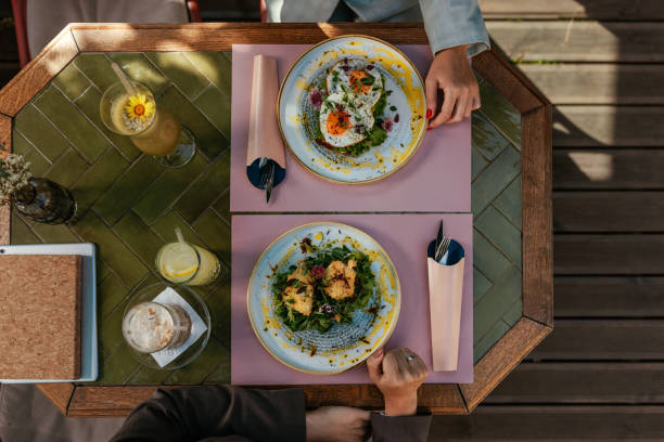 Top view of a table at a cafe with breakfast food and drinks
