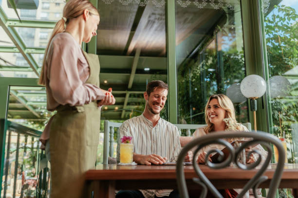 istock Couple ordering a meal in a modern restaurant 2167363313