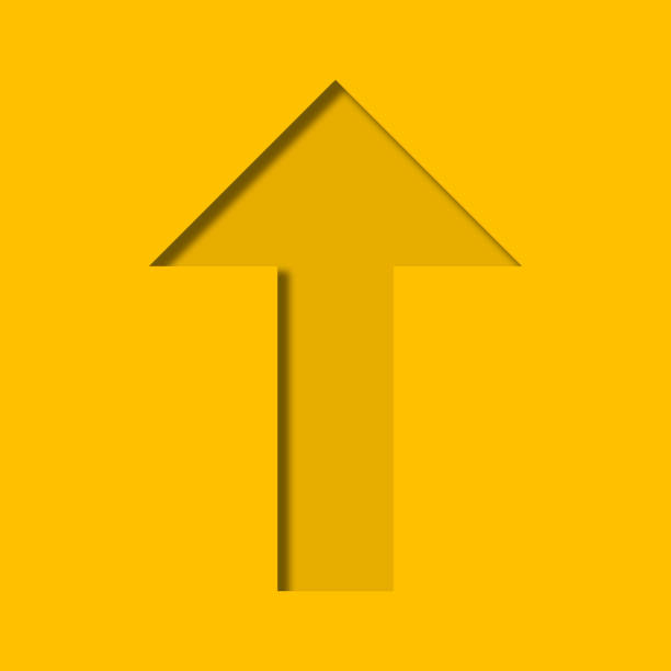 Yellow paper cut into holes arrow shape are overlaid with light and shadow and have copy space.