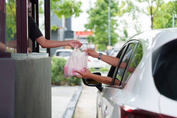 istock Men pick up food from drive-thru, drive-thru and take-out counters during off-hours. 2167364272