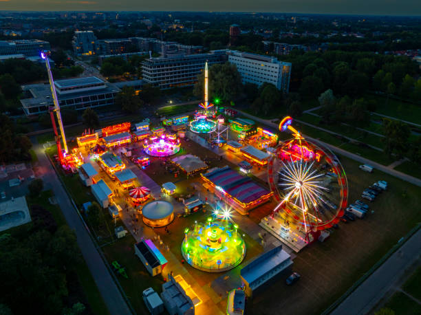 istock Fair during sunset with illuminated fairground attractions seen from above 2167364633