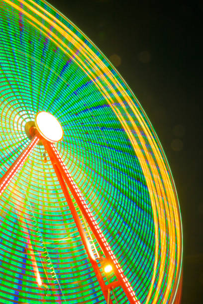 istock Fair at night with illuminated fairground attractions 2167364763