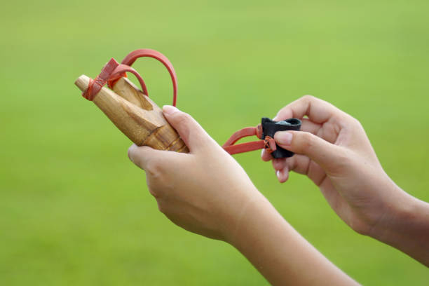 rustic wooden slingshot made with rubber and leather strips