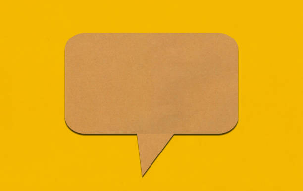 istock Brown paper speech bubble on yellow paper background. 2167365815
