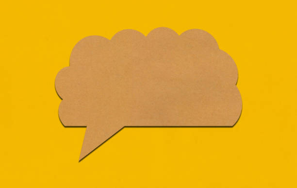 istock Brown paper speech bubble on yellow paper background. 2167365838