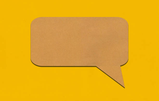 istock Brown paper speech bubble on yellow paper background. 2167365842