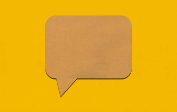 istock Brown paper speech bubble on yellow paper background. 2167365843