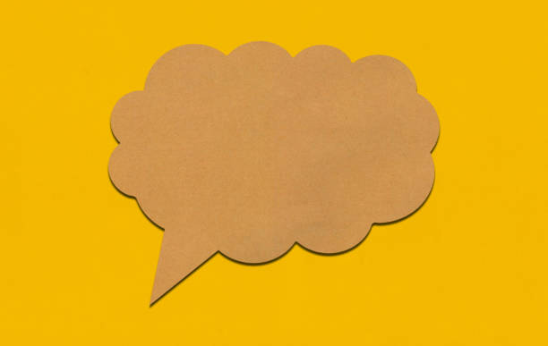 istock Brown paper speech bubble on yellow paper background. 2167365845